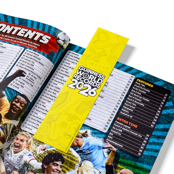 Open book with a yellow bookmark titled 'Guinness World Records 2026' on a sports-themed page.