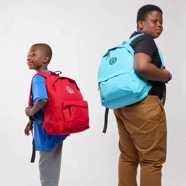 Two children wearing colorful backpacks on a plain background