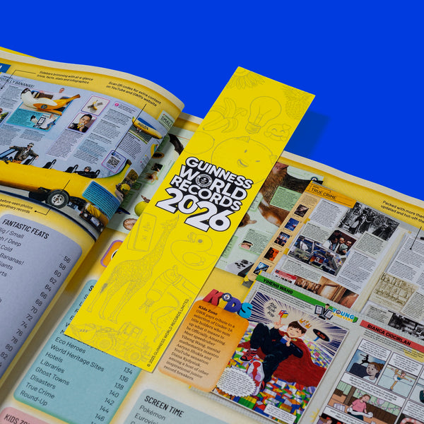 Open book with a yellow bookmark titled 'Guinness World Records 2026' on a blue background