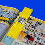 Open book with a yellow bookmark titled 'Guinness World Records 2026' on a blue background