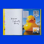 Open book showing a page from 'Guinness World Records 2026' with signature of the book editor and a large yellow rubber duck on a blue background.
