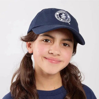 Child wearing a navy blue cap with a Guinness World Records logo on a white background